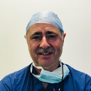 Smiling surgeon in scrubs
